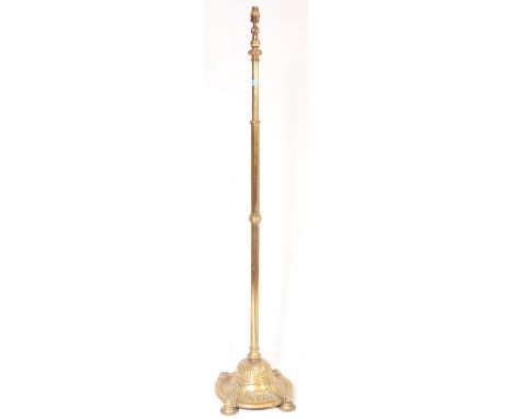 A Victorian 19th century brass standard lamp having of reeded columnar upon a circular base with gadrooning and adjustable to