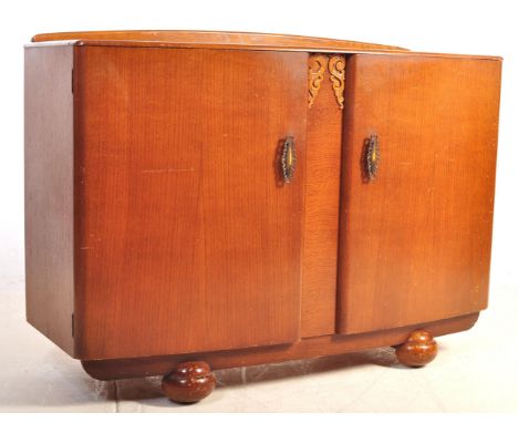 A mid century / post war Art Deco oak veneer sideboard credenza. Raised on bun feet with twin wide doors having appointed int