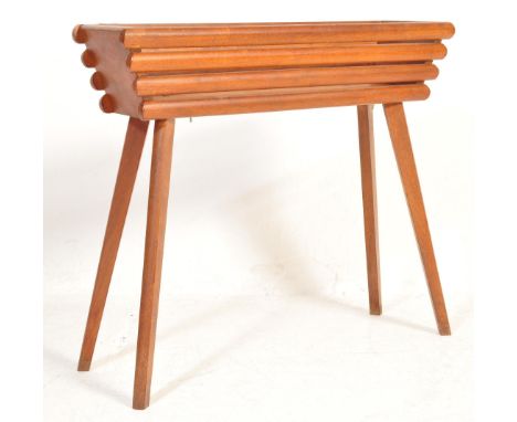 A retro vintage mid 20th century teak planter plant stand having a rectangular over tapering splayed legs. Measures 62cm x 70