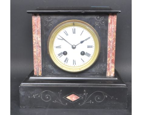 An early 20th century circa. 1900 slate Neoclassical mantle clock having a white enamelled face with black roman numeral to t