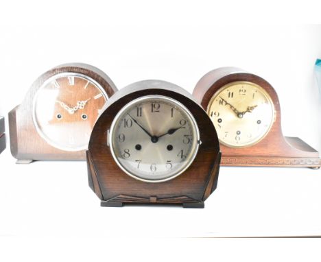 A collection of three early 20th century circa. 1930's mantle clocks. Each mantel clock having a domed oak case with either r