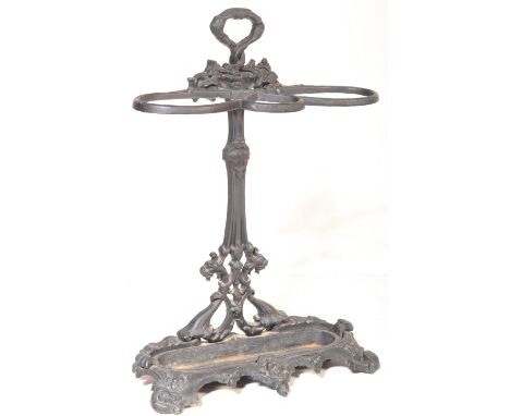 A 19th century Victorian Coalbrookdale style cast metal umbrella stick stand having cast florals and berries over three hoops