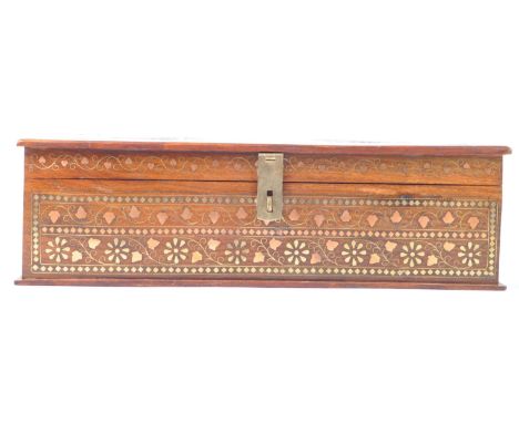 A 20th century Indian trinket box, handcrafted from sheesham wood with brass and copper inlay, with hand carved foliate decor