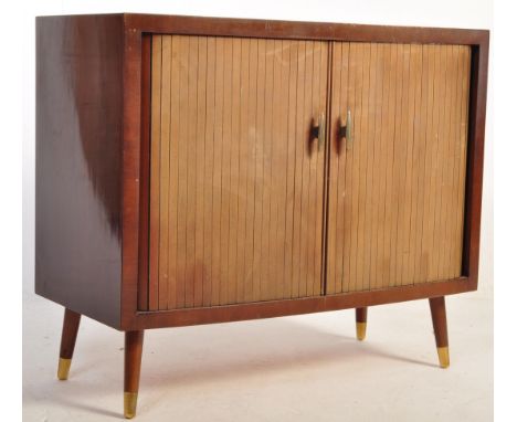 A retro vintage mid 20th Century teak record cabinet. Having a tambour fronted roller door raised on spindle legs. Measures a