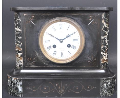 An early 20th century circa. 1900 black slate mantle clock having a white enamelled clock face with roman numeral set beneath