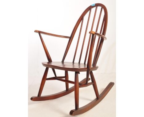 Lucian Ercolani for&nbsp; Ercol Furniture. A beech and elm wood&nbsp; rocking chair - armchair. Hoop back rest shaped elbow s