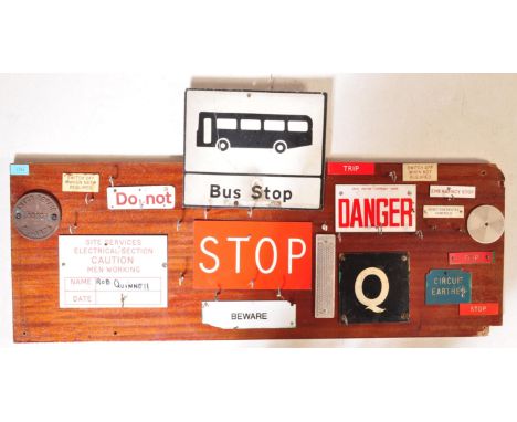 A retro 20th century wooden panel and vintage enamel and street sign coat rack. The wooden panel with applied signs for Bus S