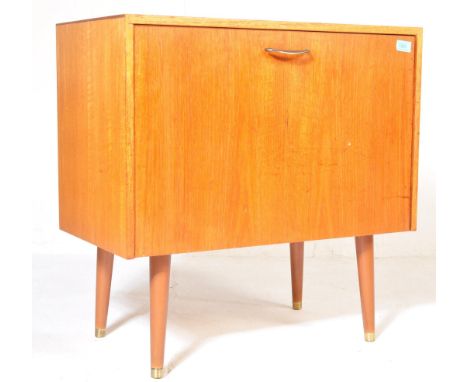 A retro vintage mid 20th century circa. 1960's teak wood record cabinet having a single fold down cupboard door with chrome b