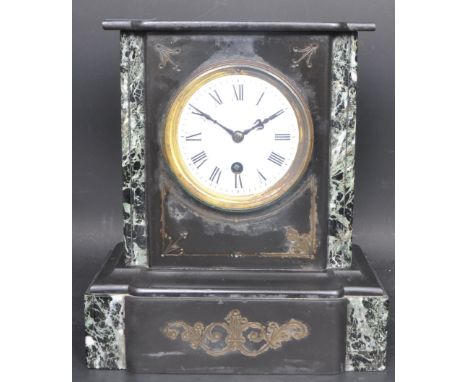 An early 20th century circa. 1900 slate mantle clock of classical form having a gilt metal dial with enamelled white clock fa