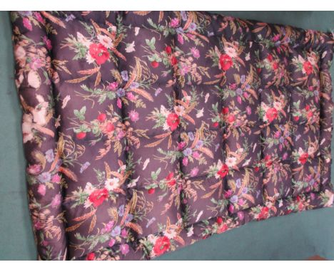 A 1950's black sateen feather filled eiderdown depicting a bold floral pattern, 190cm x 126cm.  A/F in some areas 