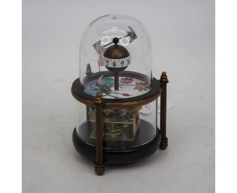 A reproduction automaton clock, the globular hour aperture surmounted by two fish above an enamelled panel with visible movem