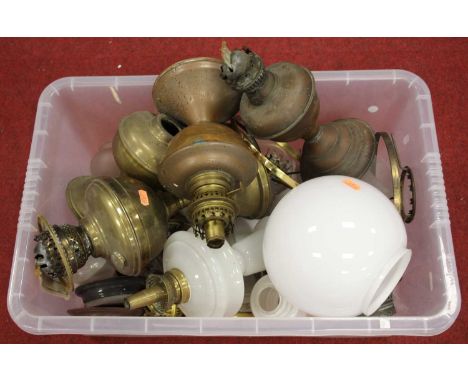 A collection of Victorian brass oil lamp parts and shades 