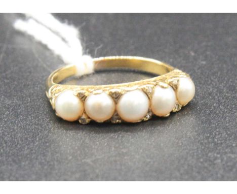 A yellow metal and cultured pearl half-hoop ring, the five pearls in a carved scroll setting and each dispersed with two rose