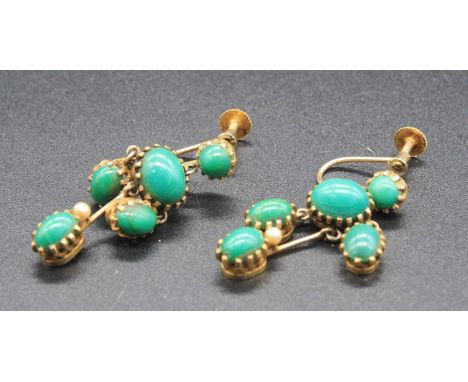 A pair of early 20th century yellow metal and turquoise set ear pendants, each having screw-back fittings, set with five turq