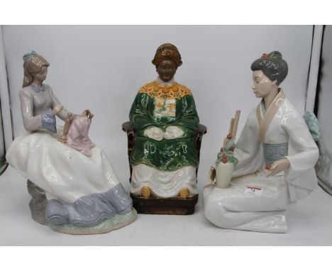 A large Nao Spanish porcelain figure modelled as a geisha girl in kneeling pose with a vase of flowering bamboo upon her lap,