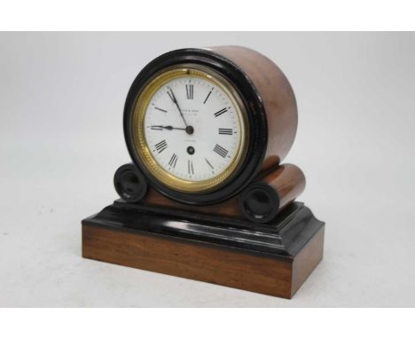 A Victorian walnut and ebonised drum shaped mantel clock having a circular enamel dial with Roman numerals and 30 hour moveme