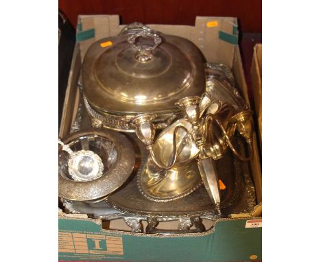 A collection of silver plated wares, to include serving trays and a twin branch table candelabra 