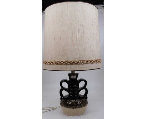 A 1970s table lamp having loop handles on a brown/cream ground with cylindrical shade, height 63cm