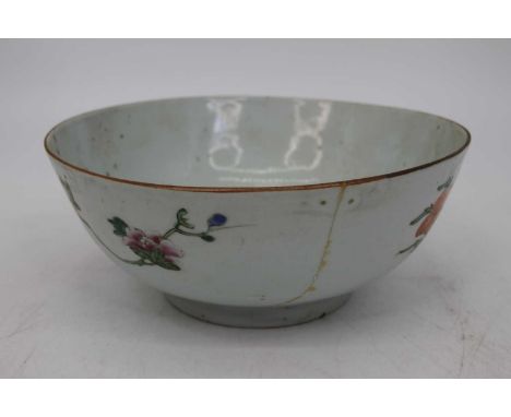 A 19th century Chinese export bowl, enamel decorated with flowers within a landscape, dia. 24cmA large break, has had rivet r