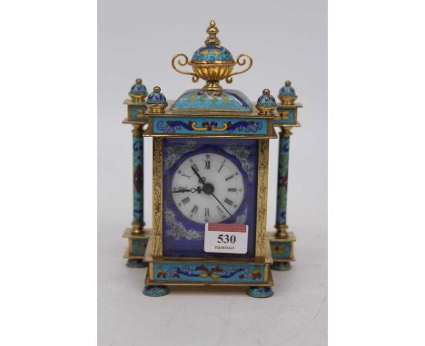 A lacquered brass and cloisonne enamelled timepiece, of architectural form, the dome top surmounted by a twin handled urn, ab