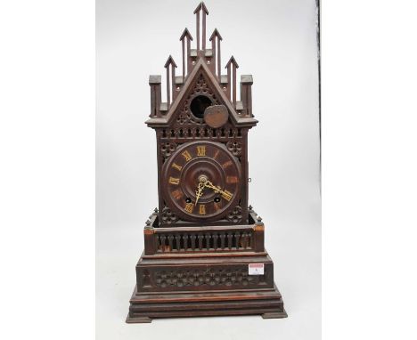 A late 19th century Continental oak cased cuckoo clock of Gothic architectural form having applied Roman numerals and eight d