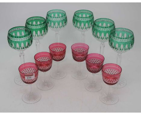 A set of six Waterford green overlaid crystal wine hocks; together with a set of six cranberry overlaid drinking glassesThe c