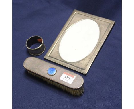 An Edwardian silver plated dressing table brush, having blue enamel cabochon, 16cm; together with a silver-clad photograph fr