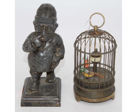 A reproduction brass cased birdcage automaton clock, h.12cm; together with a figural pewter lighter (2)