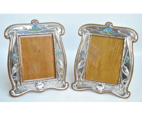 WILLIAM NEALE; a pair of large Edward VII hallmarked silver fronted Art Nouveau shaped rectangular photo frames embossed with