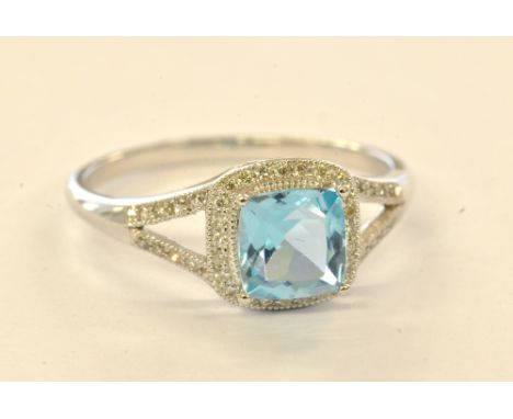 A 9ct white gold diamond and blue topaz ring, size N, approx 2g, sold with GIE report.