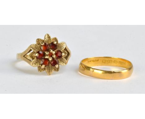 A 9ct yellow gold cluster ring set with seven garnets within border of mould leaves with pierced shanks, size K1/2, and a 22c