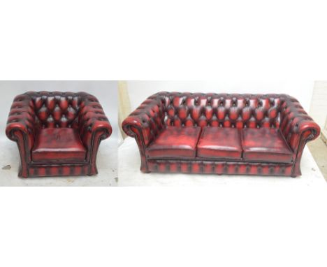 A red leather Chesterfield three seat sofa and armchair.