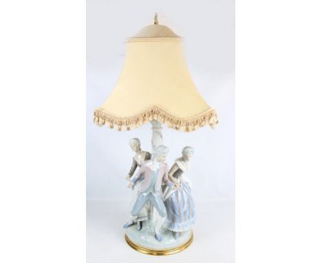 A Lladro figural lamp base, 1124, with a man and two women dancing around a Corinthian column, height excluding fitment but i