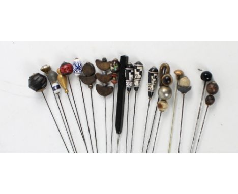 A collection of mainly wood, hardstone and resin medium length hat pins including three geometric painted examples, a ceramic
