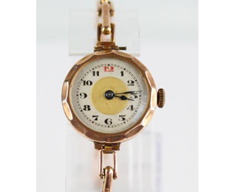 An early 20th century 9ct gold manual wind lady's wristwatch, the circular dial set with Arabic numerals, on expandable brace