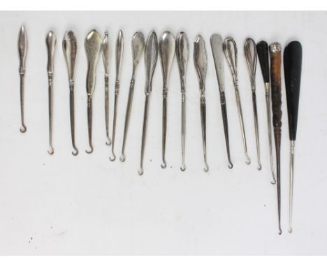 A collection of variously sized hallmarked silver sheath handles buttonhooks, with engine turned decoration, flat and smooth 