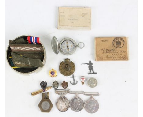 A collection of medals to include the 1939-1945 Medal and the Territorial Medal, both awarded to F.G Milnes, also cap badges,