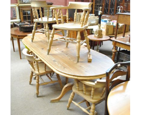 A modern pine twin pedestal dining table and a set of six bow back chairs with saddle seats and ring turned support legs (7).