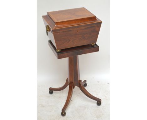 An early 19th century rosewood and boxwood strung teapoy, the sarcophagus upper section with hinged lid enclosing four canist