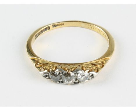 An 18ct yellow gold dress ring set with three graduated diamonds, size P, approx 3g.