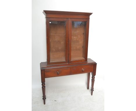 A Victorian mahogany two drawer side table on ring turned front legs, width 118cm, and a glazed bookcase top, height 105cm (2