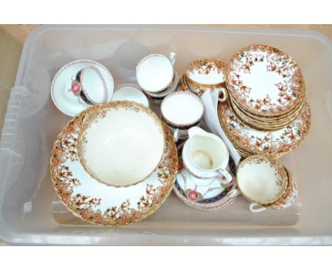 A Doric china six setting tea service with floral gilt decoration on a blue and white ground and a floral and foliate decorat