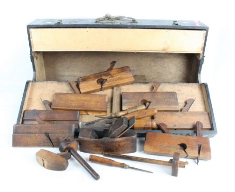 A toolbox containing a collection of early 20th century tools, predominantly moulding planes.