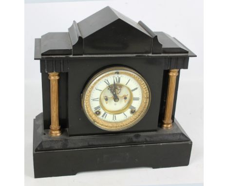 A late 19th century American Ansonia Clock Co black slate mantel clock, the circular dial set with Arabic numerals, flanked b