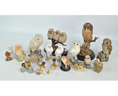 A collection of mainly ceramic owls including Royal Doulton Snowy Owl, previously a decanter, Beswick owl 2026, Aynsley Snowy