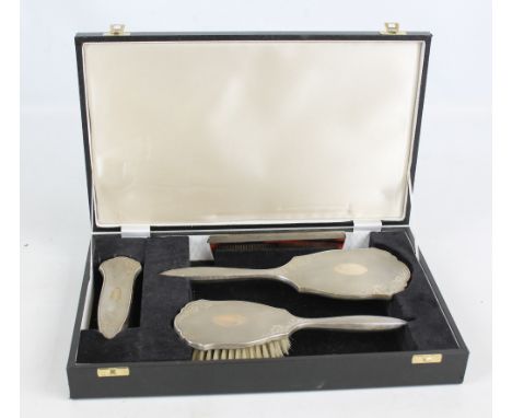 WI BROADWAY & CO; a cased Elizabeth II hallmarked silver backed four piece dressing table set comprising a hand mirror, lengt