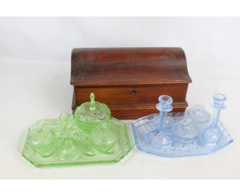 A walnut domed box with hinged lid, a large brass letter clip and two glass dressing table sets, both with trays, candlestick