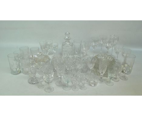 A quantity of various clear cut glass drinking glasses, also a rectangular tray, an ashtray and a square sectioned decanter.