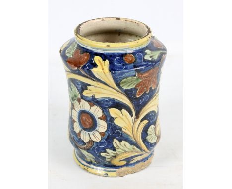 A 17th/18th century Italian Maiolica albarello or drug jar with floral decoration on a blue ground, height 20.5cm (af). CONDI