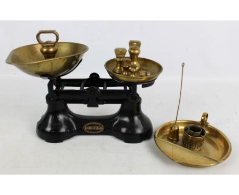 An early 20th century painted iron set of kitchen scales by Scotts of Stowe, width 27cm with assorted set of bell weights and